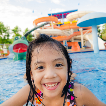 Young girl swimming at a water park - Pediatric Dentist in Henderson ad Las Vegas NV