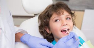 Young boy getting his teeth examined - Pediatric Dentist in Henderson ad Las Vegas NV