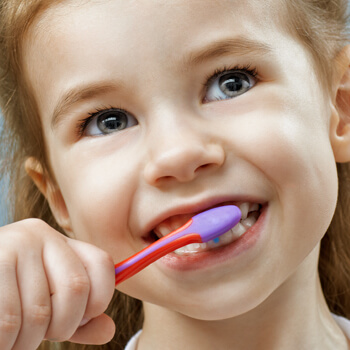 Little girl brushing her teeth - Pediatric Dentist in Henderson ad Las Vegas NV